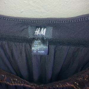 Black dress with studs around the collar.